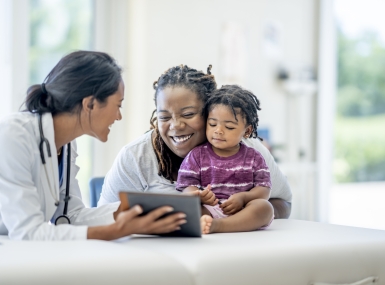 A young Mother and her son visit the doctor together.