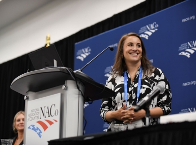 Photo: Lily Ballengee describes the outreach efforts the U.S. Department of Transportation is engaging in to spread the news of its ROUTES Initiative. Photo by Lana Farfan