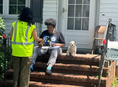 A member of the Union County Outreach Team talks with a resident about services available through the county. Photo courtesy of the Civic Operations Group