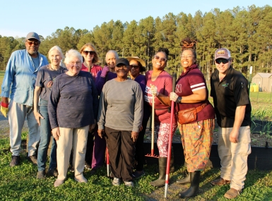 Gwinnett County, Ga. volunteers pause for a photo at Vines Community Garden at Vines Park, where crops are grown for residents.