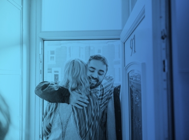 Man and woman embracing in doorway