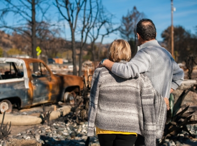 Couple checking ruins after fire disaster