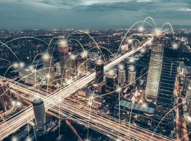 Aerial view of city with beams of light bouncing from building to building