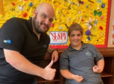 Siena Dann, a Crystal Academy student training to be a library volunteer, poses with Coral Gables Library Branch Manager Brent Capley. Photo courtesy of Maria Palacio