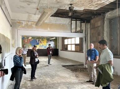 City of Fayette Councilmember Gabe Peña shows BRECC Coalition members the under renovation High School to housing project. 