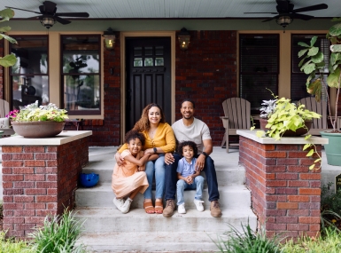 Family in front of house