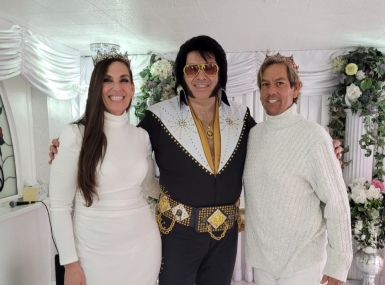 Diana and Charles Printzen pose with an Elvis Presley impersonator after getting married at the Little White Wedding Chapel in Clark County, Nev.