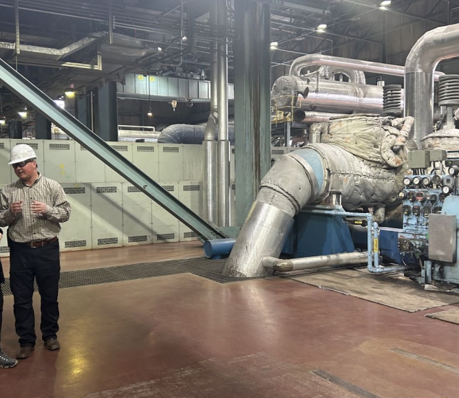 Cindy Winland, senior consultant, Interagency Working Group for Energy Communities, talks with an engineer at Naughton Power Plant in Lincoln County, Wyo.