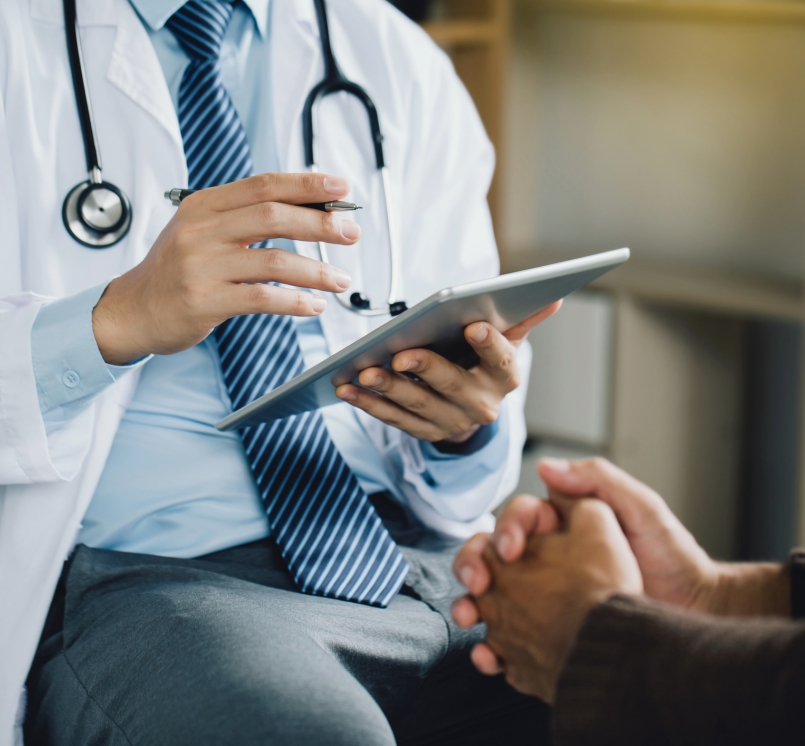 Doctor with tablet and patient