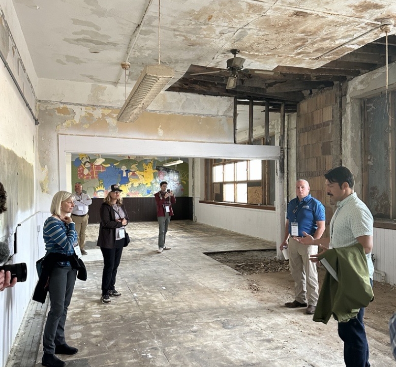 City of Fayette Councilmember Gabe Peña shows BRECC Coalition members the under renovation High School to housing project. 