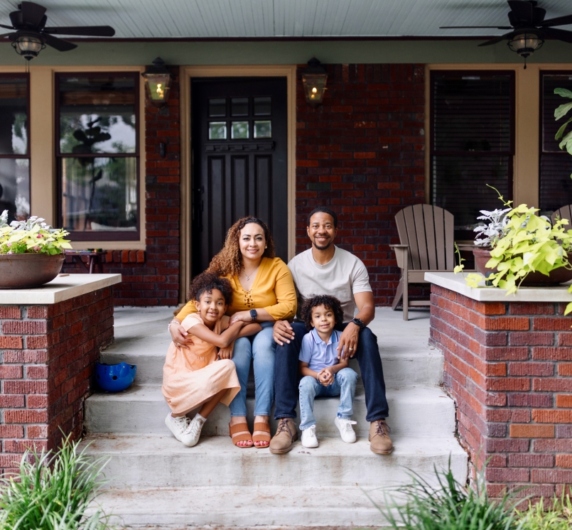 Family in front of house