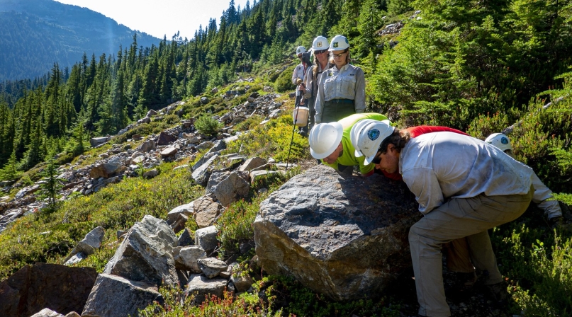 Volunteers move a boulder near the Pacific Crest Trail under the supervision of U.S. Forest Service personnel as depicted in a photo that received honorable mention in the 2020 Pacific Crest Trail Association photo contest. Photo by Mark de Hoo