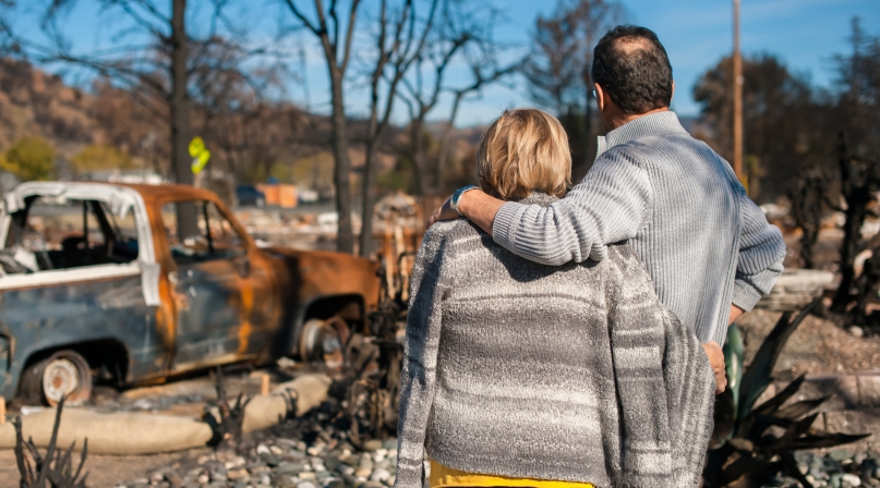 Couple checking ruins after fire disaster