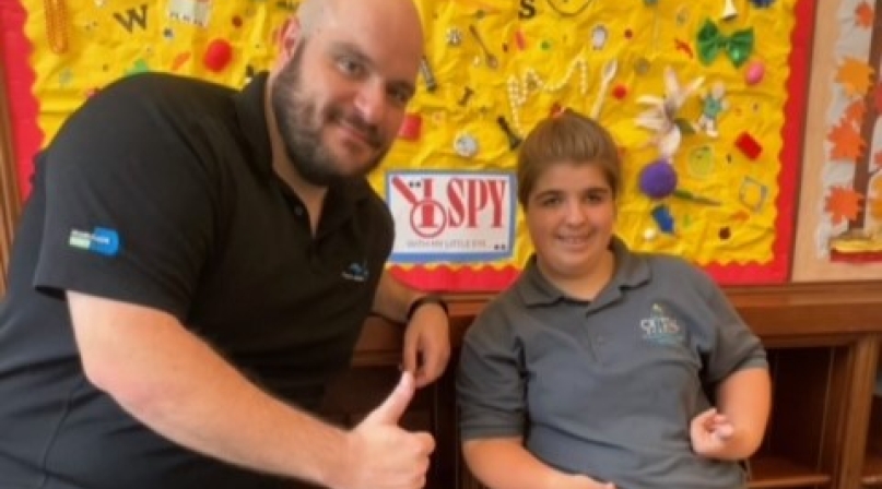 Siena Dann, a Crystal Academy student training to be a library volunteer, poses with Coral Gables Library Branch Manager Brent Capley. Photo courtesy of Maria Palacio