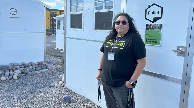 April Seat, director of Outreach for Hope Rescue Mission, shows off a pallet shelter in the Missoula County TSOS. Photo by Charlie Ban