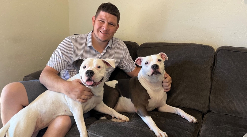 Phillip Bernard with dogs Xena and Harmonia: “I don’t know where I’d be without OPCS, probably in prison. They laid out the foundation for me to be where I am today.” Since getting connected to Housing First, he is sober, studying for his GED and taking computer programming classes.