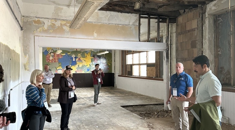 City of Fayette Councilmember Gabe Peña shows BRECC Coalition members the under renovation High School to housing project. 