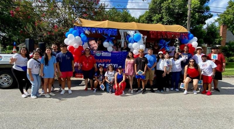 Student2Government Leadership Academy students pose in front of a Fourth of July float they made.