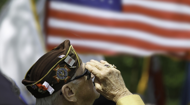 Veteran saluting flag