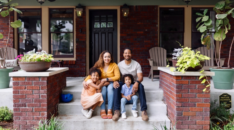 Family in front of house