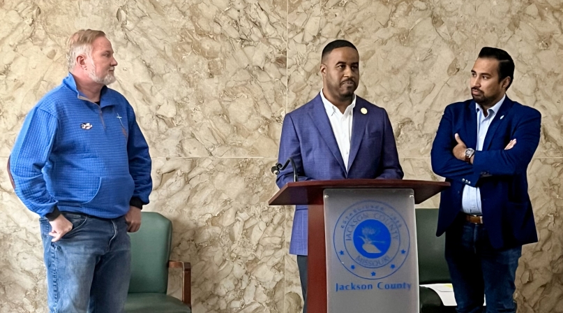 DaRon McGee speaks at a press conference flanked by Jackson County legislator colleagues Sean Smith (left) and Manuel Abarca.