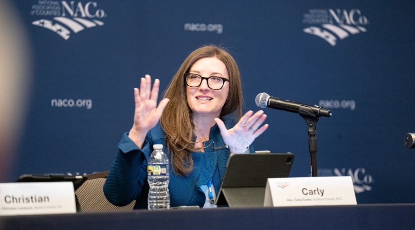 Guilford County, N.C. Commissioner Carly Cooke, vice-chair of the Midsize County Caucus Exploratory Committee, makes a point March 2 before a crowded room. Photo by Denny Henry