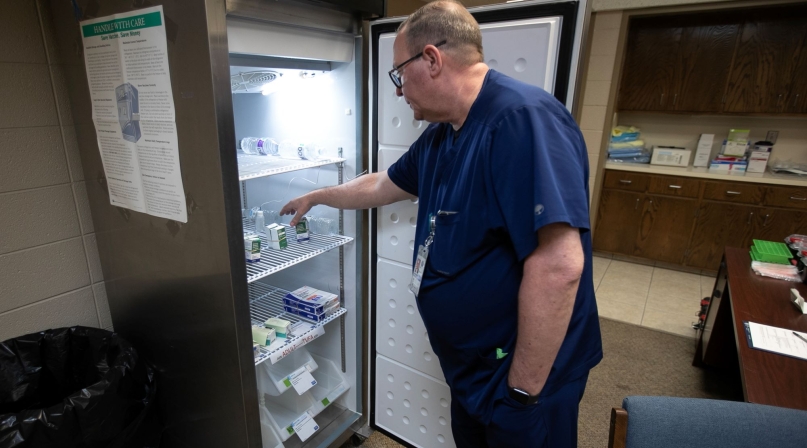 Andrews County Health Department director Gordon Mattimoe looks over the supply of refrigerated measles vaccines at the old City Hall building in Andrews, Texas. Photo by Mark Rogers for The Texas Tribune