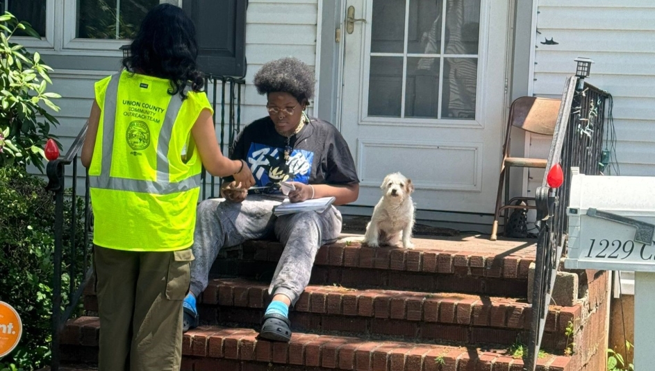 A member of the Union County Outreach Team talks with a resident about services available through the county. Photo courtesy of the Civic Operations Group