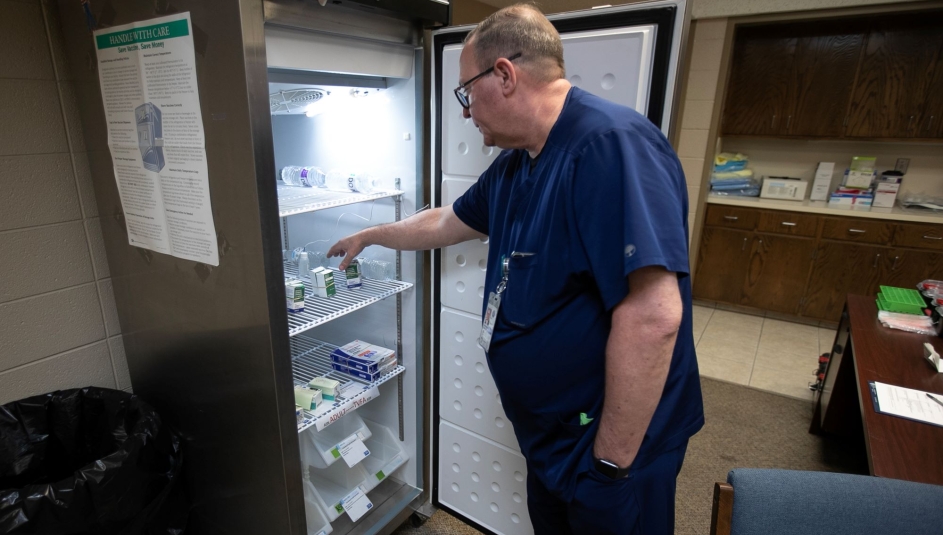 Andrews County Health Department director Gordon Mattimoe looks over the supply of refrigerated measles vaccines at the old City Hall building in Andrews, Texas. Photo by Mark Rogers for The Texas Tribune