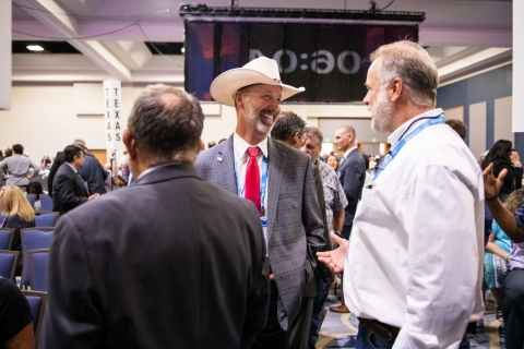 Ravalli County, Mont. Commissioner Greg Chilcott talks to colleagues before the General Session at the 2022 NACo Annual Conference. Photo by Denny Henry